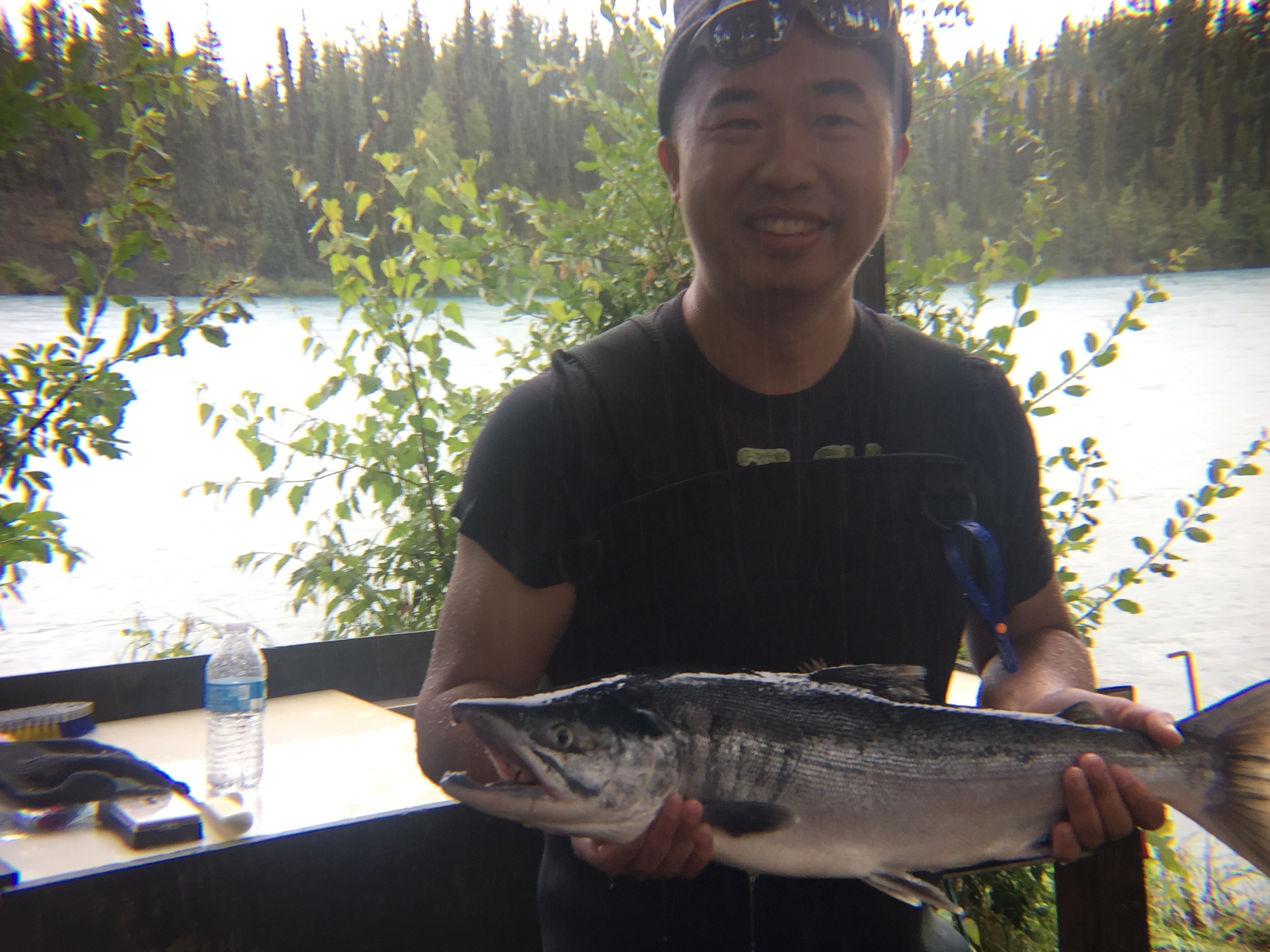 Billy 在阿拉斯加河邊抱著親手釣上的三文魚